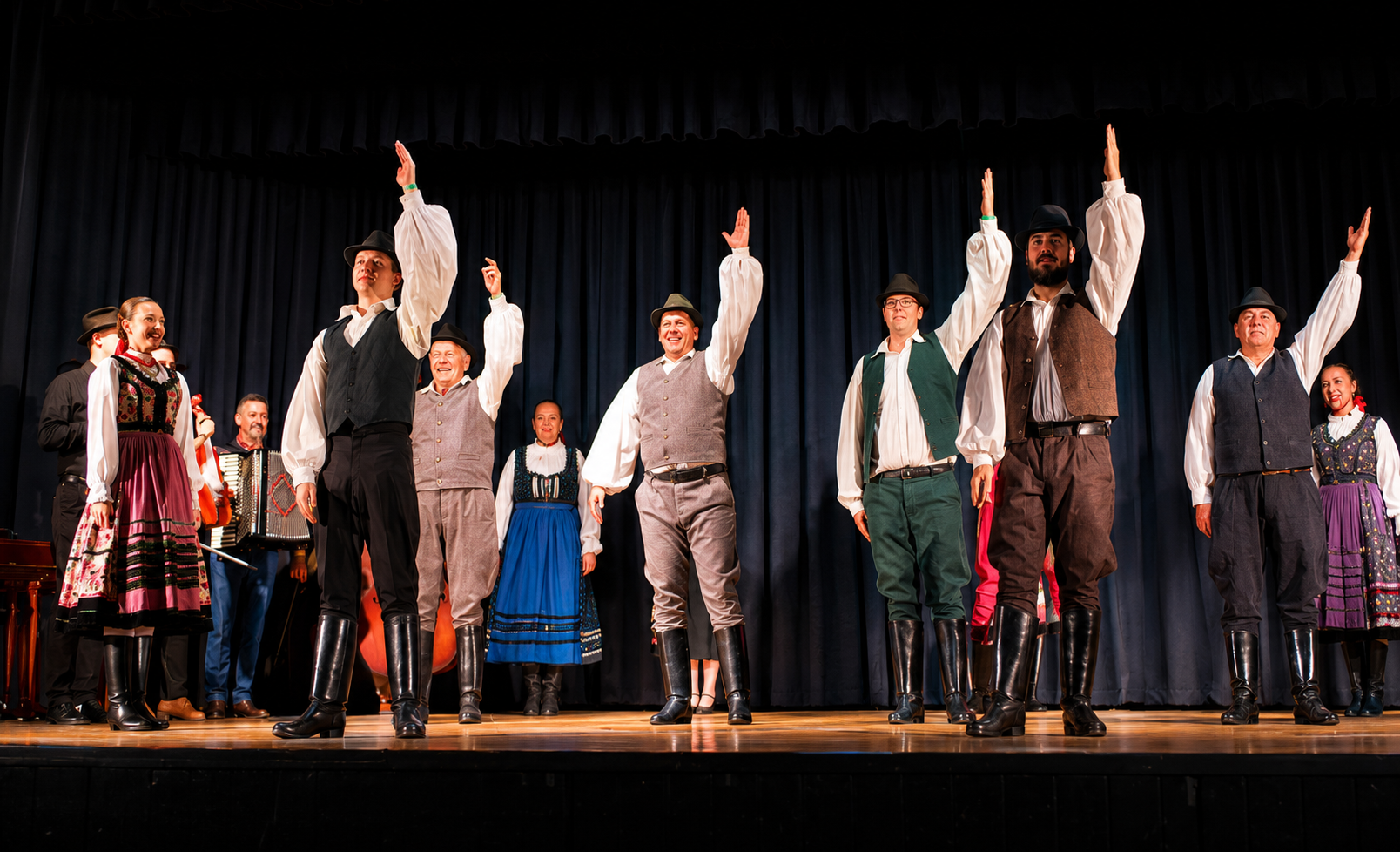 Male folk dancers performing with raised arms